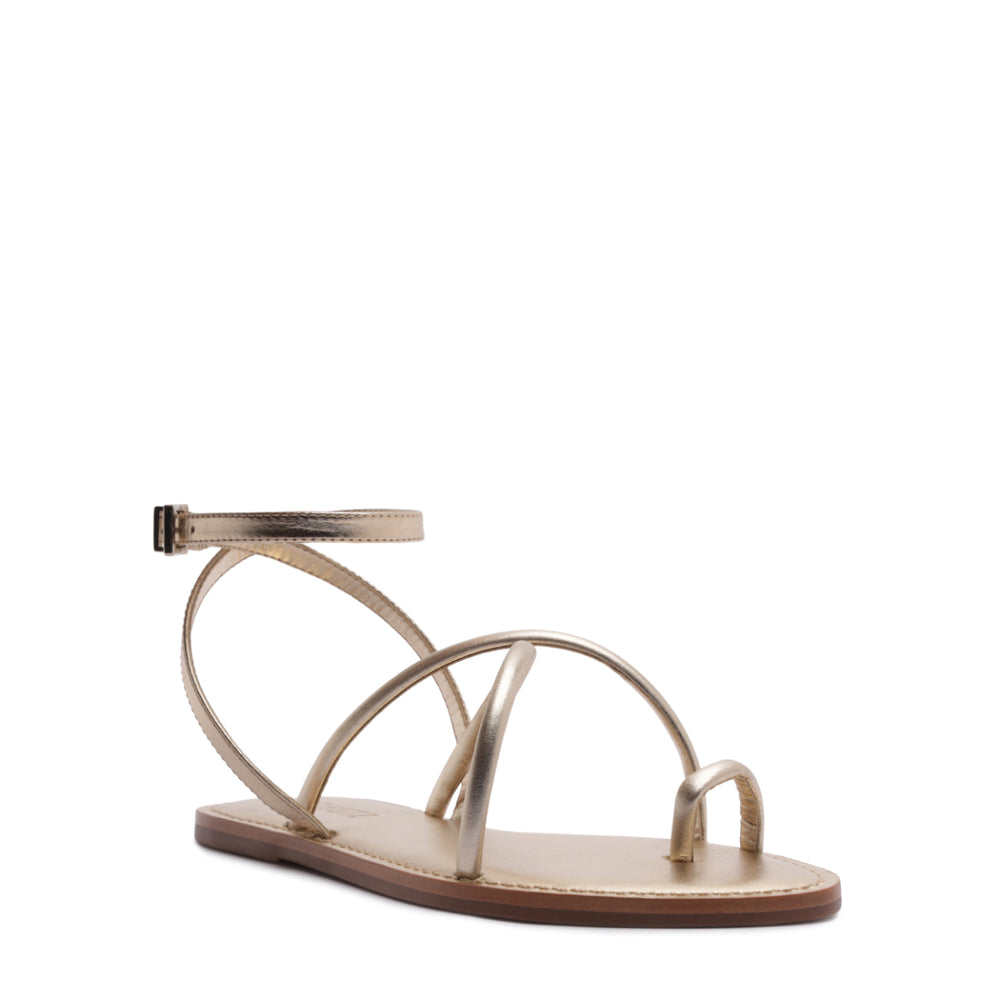 Three-quarter view of Valeria sandal in platinum showcasing metallic asymmetrical straps, toe loop and ankle strap on white