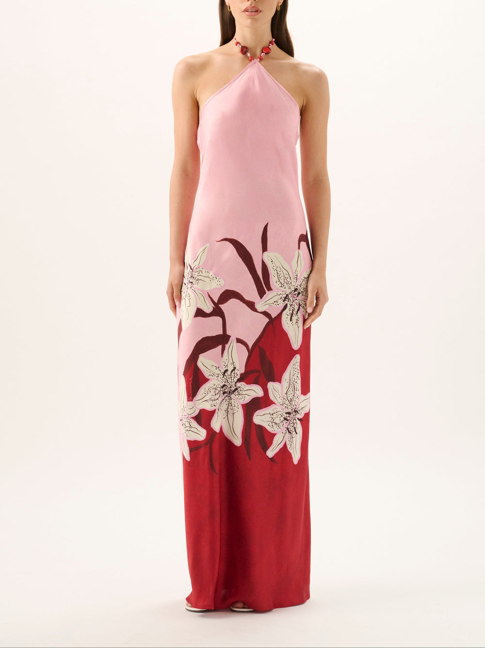 Front view of Tallulah halter maxi dress in Liliana on model, pink-to-red gradient, beaded halter tie, floral print