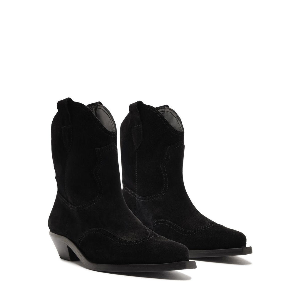 Three-quarter view of Nash Suede Bootie in Black showcasing pointed toes and low block heels on a white background