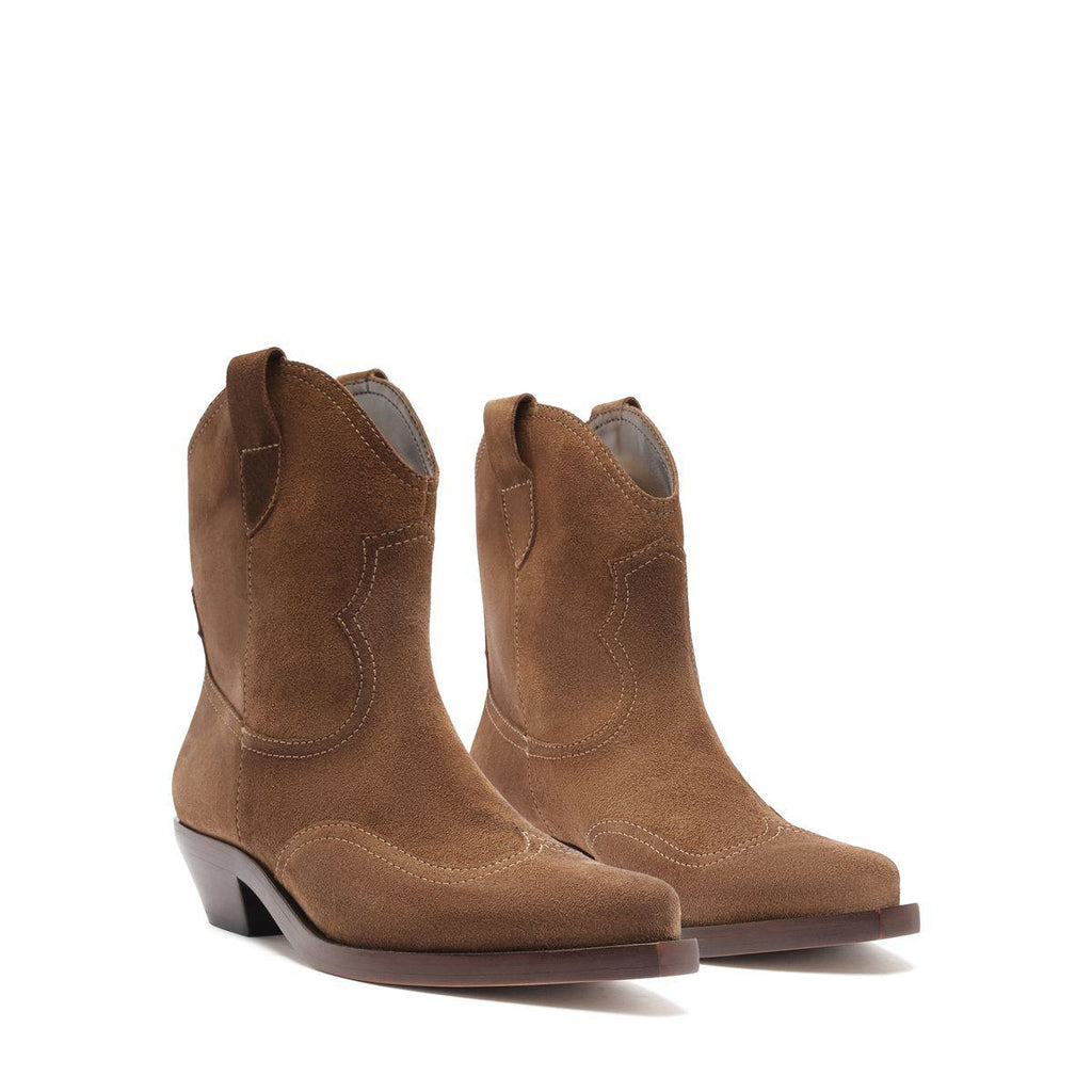 Front three-quarter view of Nash suede booties in pecan brown showcasing pointed toes and stacked heels on a white background