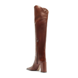 Side view of Raffaela over-the-knee leather boot in warm toffee showcasing its tall shaft and block heel against a white background