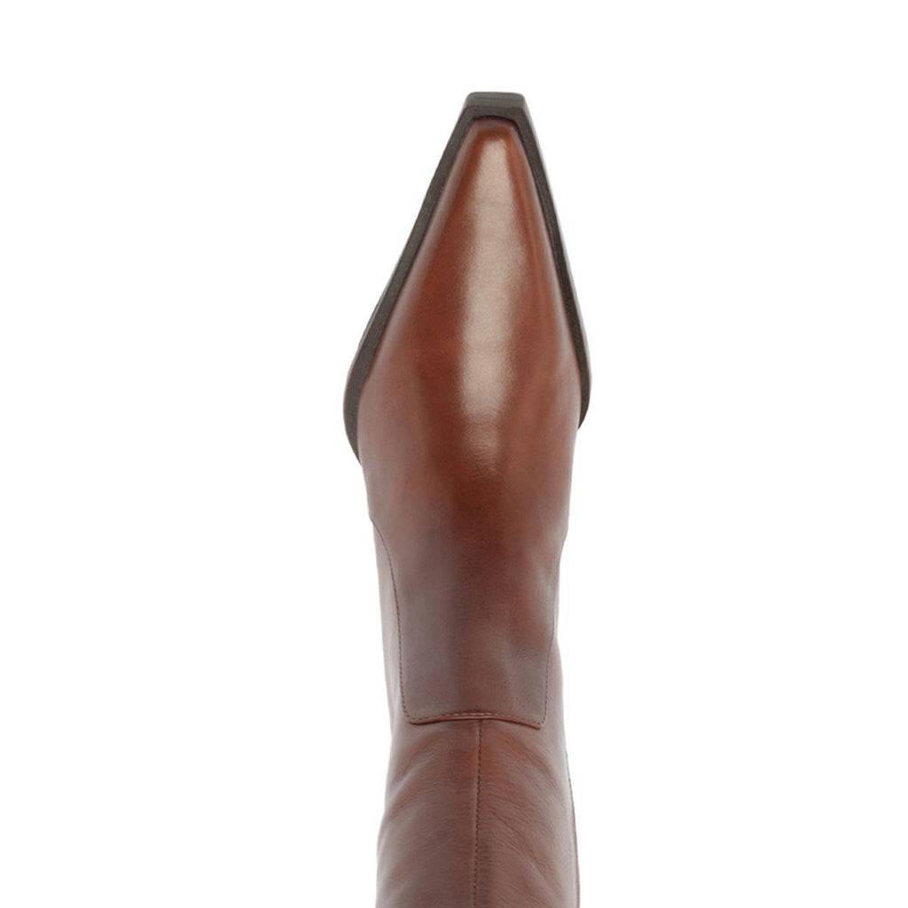 Close-up of the warm toffee Raffaela over-the-knee leather boot showcasing its pointed toe and tall shaft with a white background