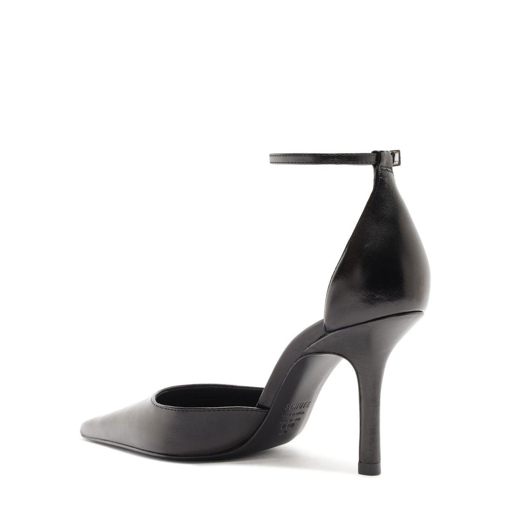 Side view of Jenny Leather Pump in Black showcasing its pointed toe, buckle detail, and stiletto heel with a white background
