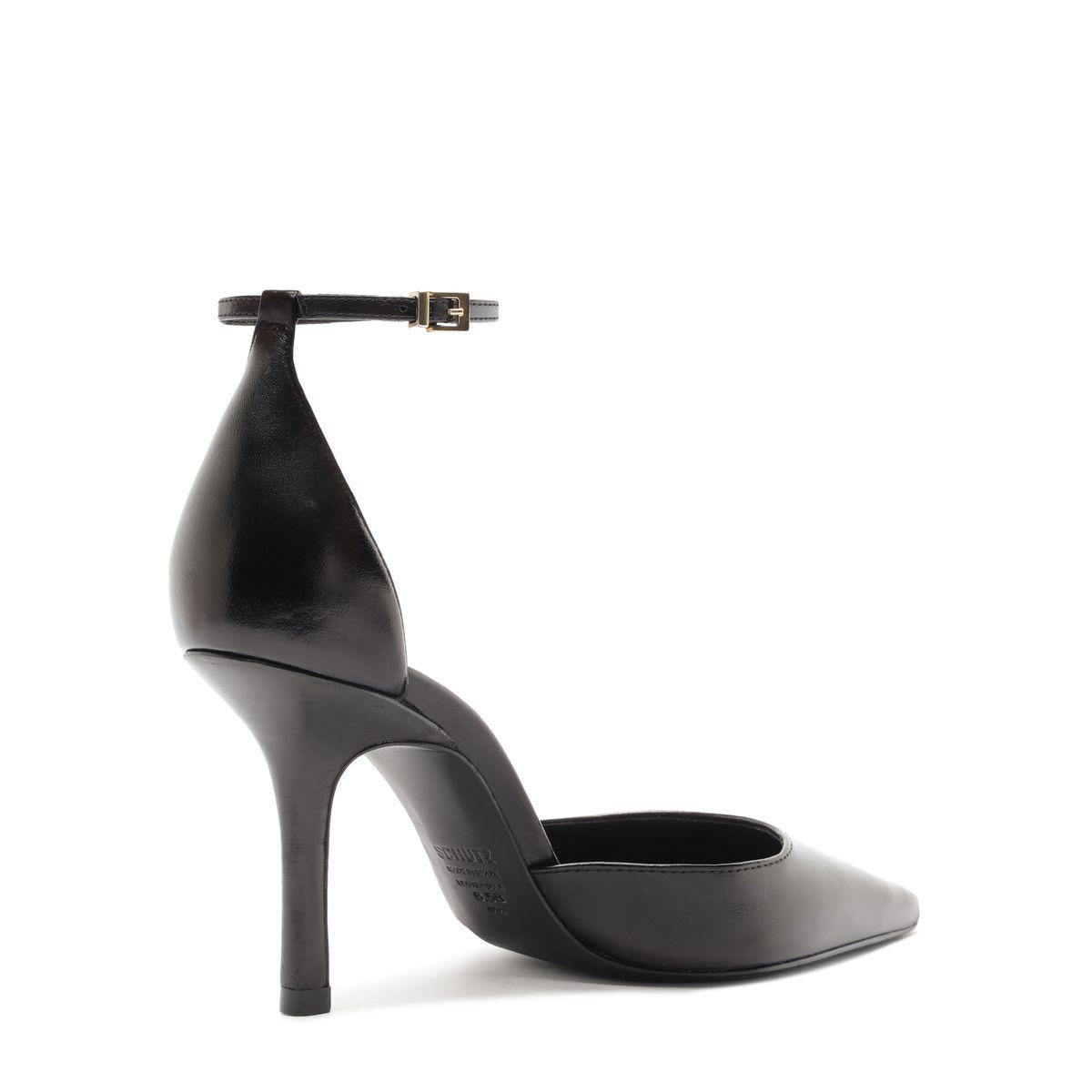 Side view of Jenny Leather Pump in Black showcasing ankle buckle, pointed toe, and stiletto heel with a white background
