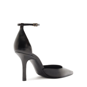 Side view of Jenny Leather Pump in Black showcasing ankle buckle, pointed toe, and stiletto heel with a white background