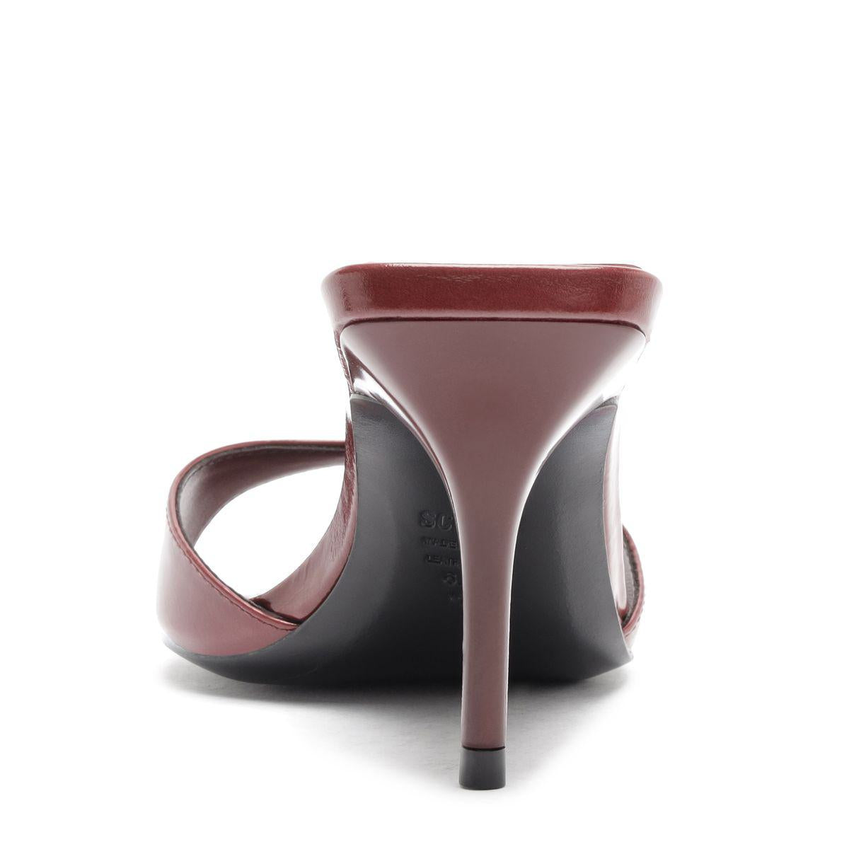 Rear view of Elodie Leather Sandal in Wine Berry showcasing its stiletto heel and open counter against a white background
