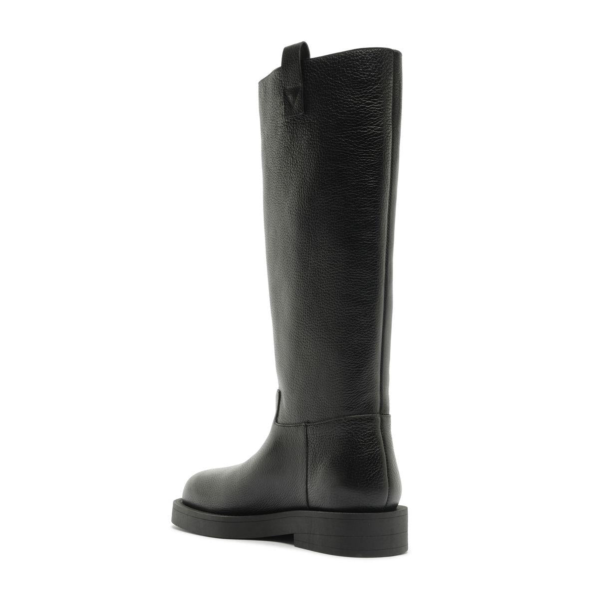 Side view of black Betty Boot showcasing knee-high shaft and block heel with white background