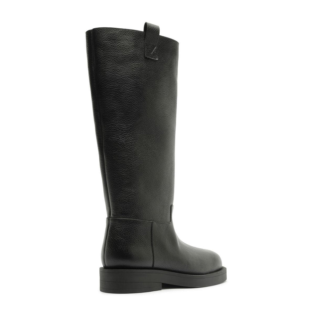Side view of the Betty Boot in Black showcasing its knee-high shaft and block heel with a white background