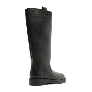 Side view of the Betty Boot in Black showcasing its knee-high shaft and block heel with a white background