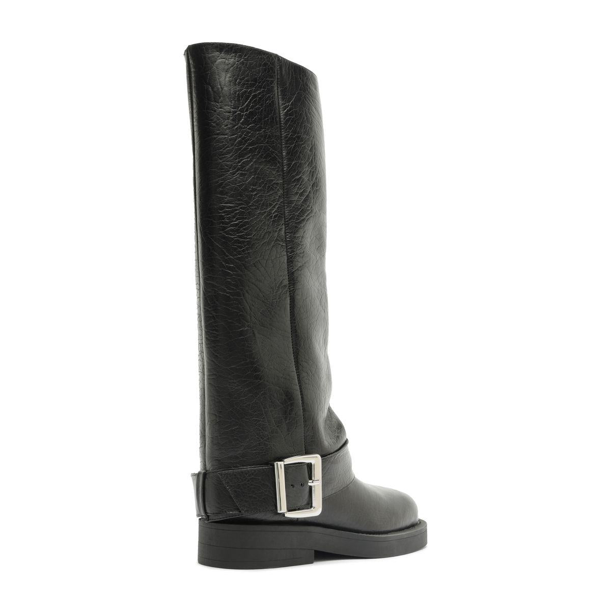 Side view of Patrice Up Boot in black showcasing its tall shaft, ankle buckle strap, and low block sole on a white background