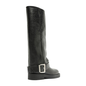 Side view of Patrice Up Boot in black showcasing its tall shaft, ankle buckle strap, and low block sole on a white background