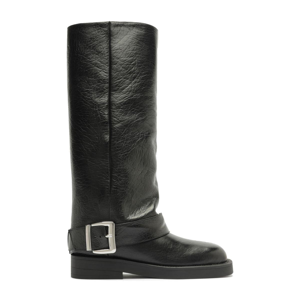 Side view of Patrice Up Boot in Black showcasing ankle buckle strap and low heel with white background
