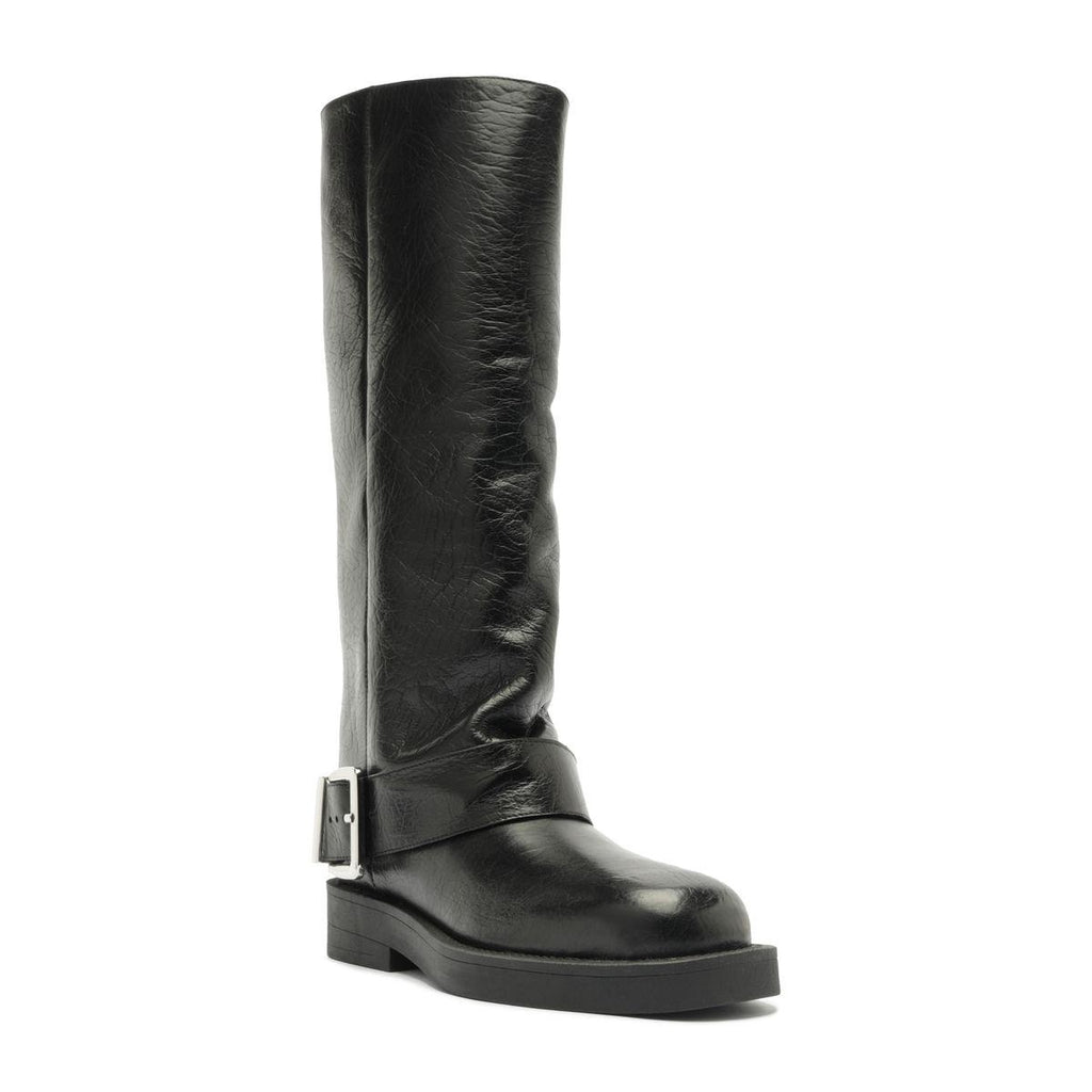 Three-quarter view of Patrice Up Boot in Black showcasing its tall ruched shaft, buckle strap, and lug sole on a white background