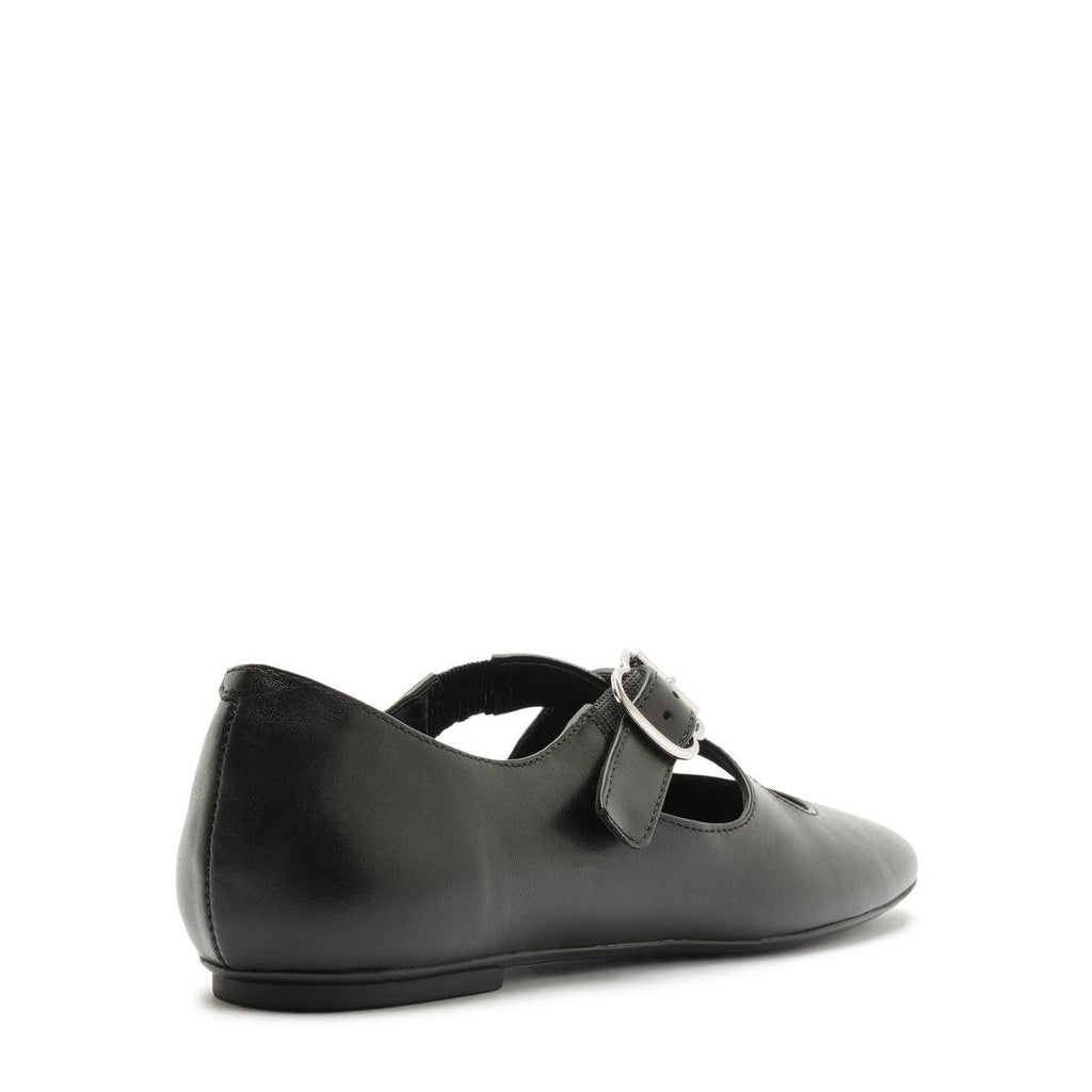 Side view of Molly Flat in Black showcasing its buckle strap and round toe with a white background
