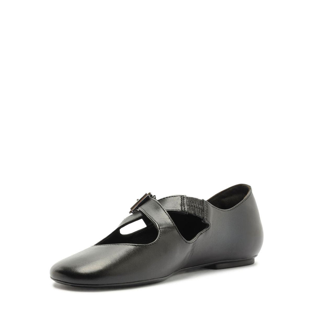 Side view of Molly Flat in Black showcasing its round toe, buckle strap, and closed counter against a white background