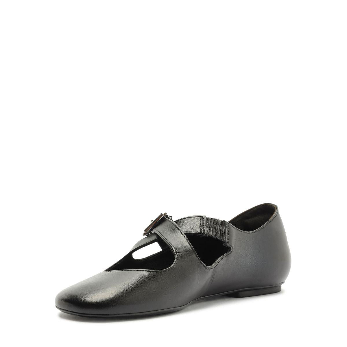 Side view of Molly Flat in Black showcasing its round toe, buckle strap, and closed counter against a white background