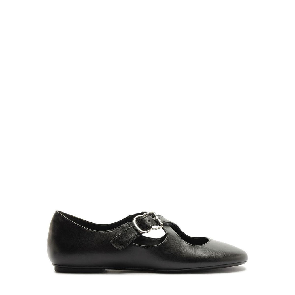 Side view of Molly Flat in Black showcasing its rounded toe and buckle strap with a white background