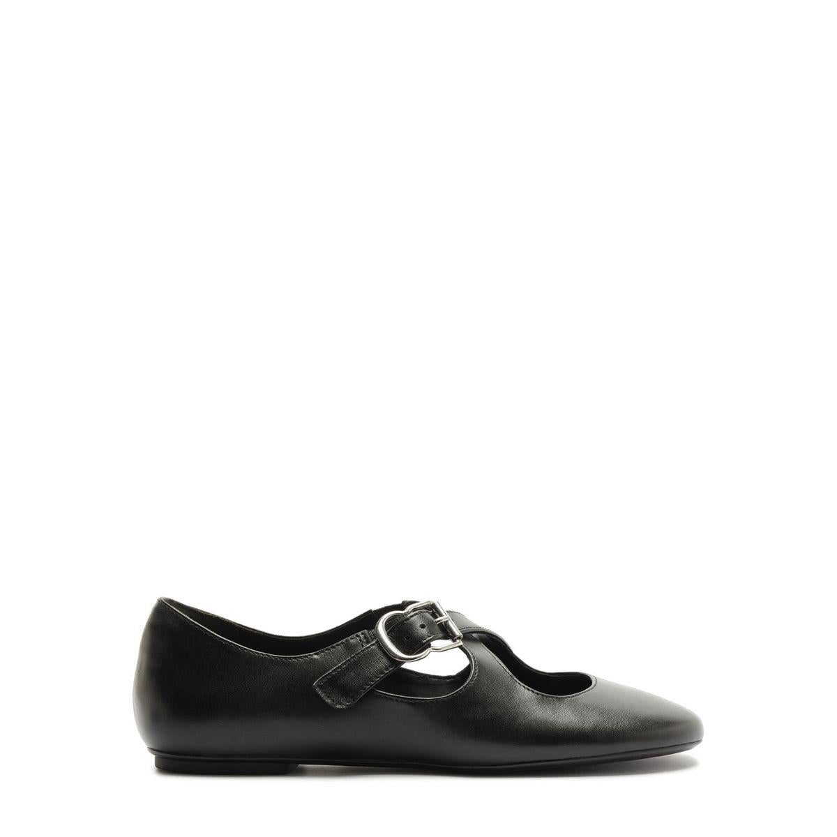 Side view of Molly Flat in Black showcasing its rounded toe and buckle strap with a white background