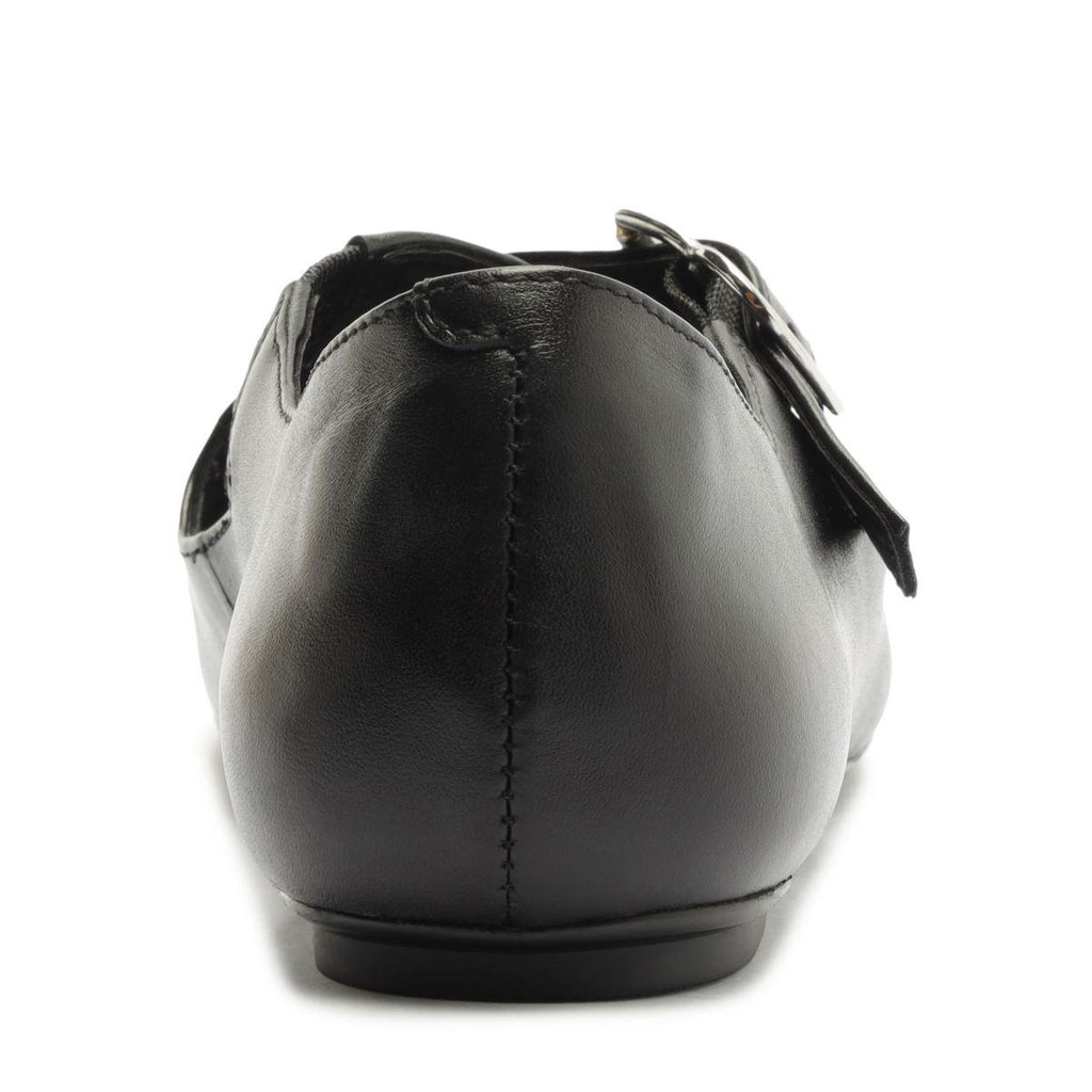 Rear view of Molly Flat in Black showcasing its closed counter and buckle strap with a white background