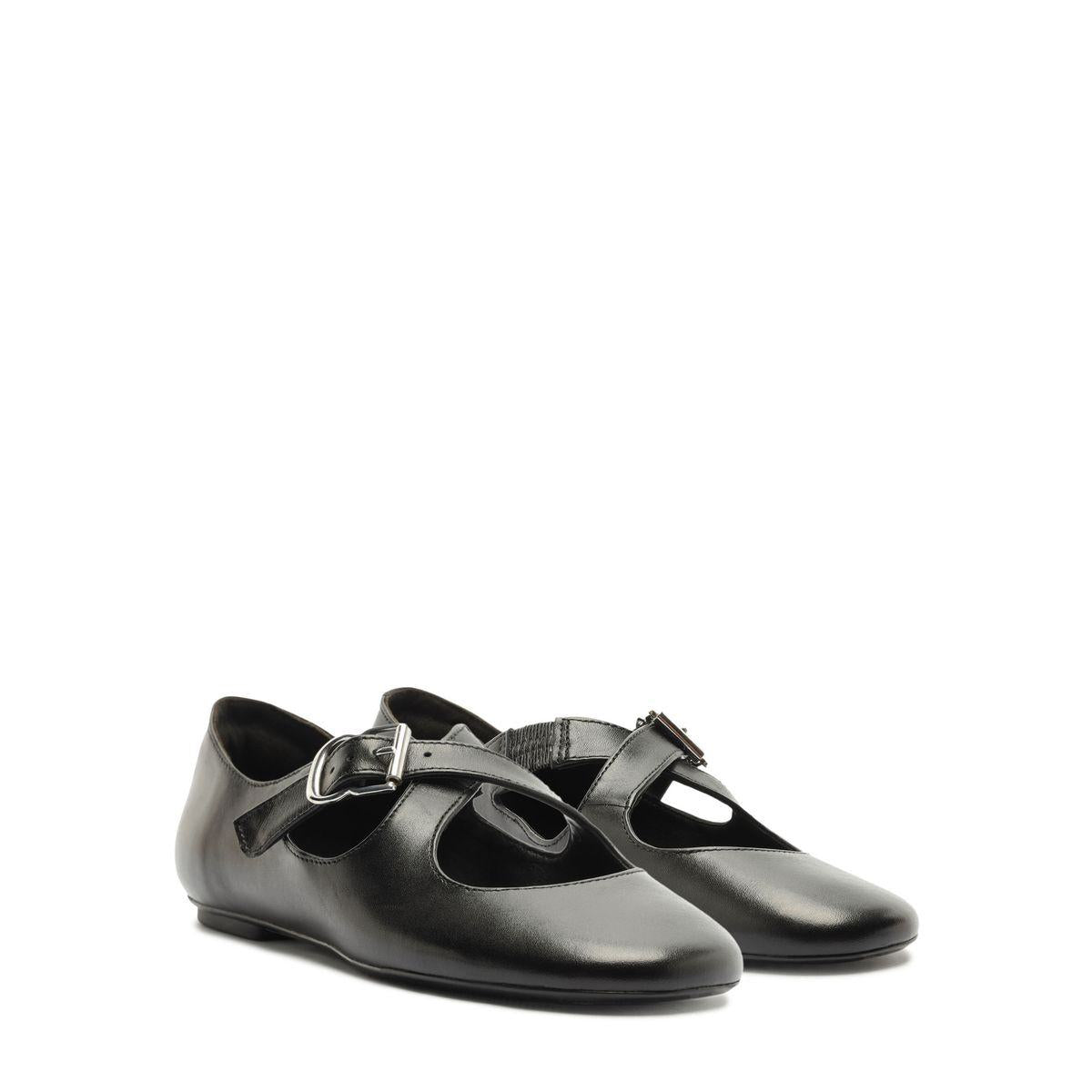 Front three quarter view of Molly Flat in Black showcasing the rounded toe and buckle strap with a white background
