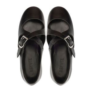 Top view of Molly Flat in Black ballet flats showcasing rounded toes and buckle straps on a white background
