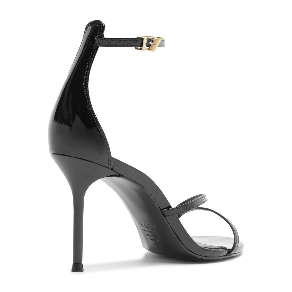Side view of Tessa Patent Sandal in Black showcasing glossy patent leather straps and stiletto heel with white background