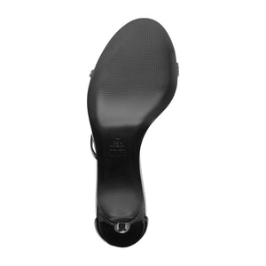 Bottom view of Schutz Tessa Patent Sandal in Black showcasing the leather outsole and stiletto heel with a white background