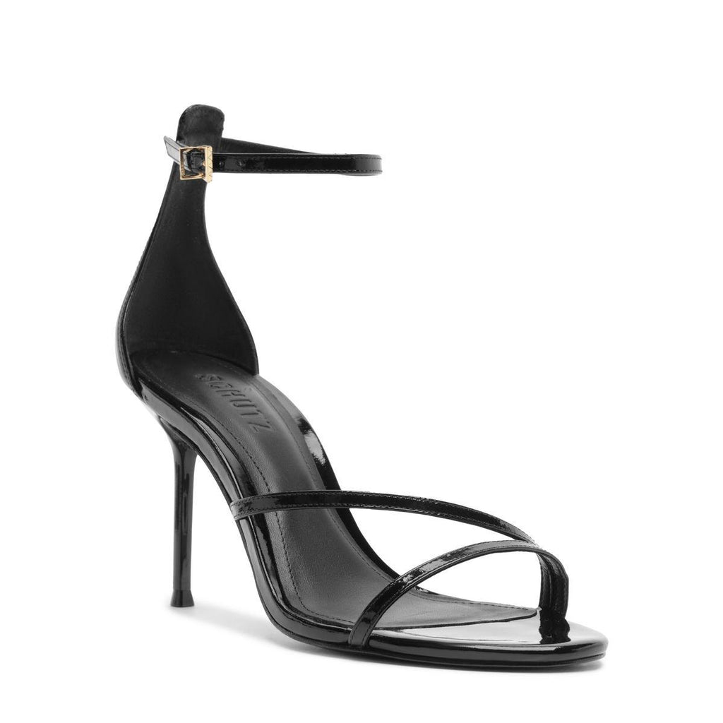Side view of Tessa Patent Sandal in Black showcasing glossy straps, ankle buckle, and stiletto heel on white background