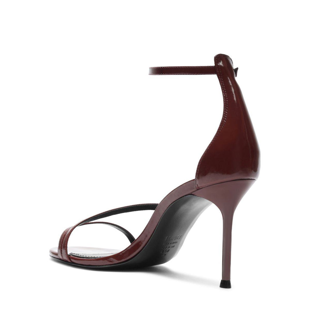 Side view of Tessa Patent Sandal in Port Burgundy showcasing glossy patent straps and high stiletto heel with a white background