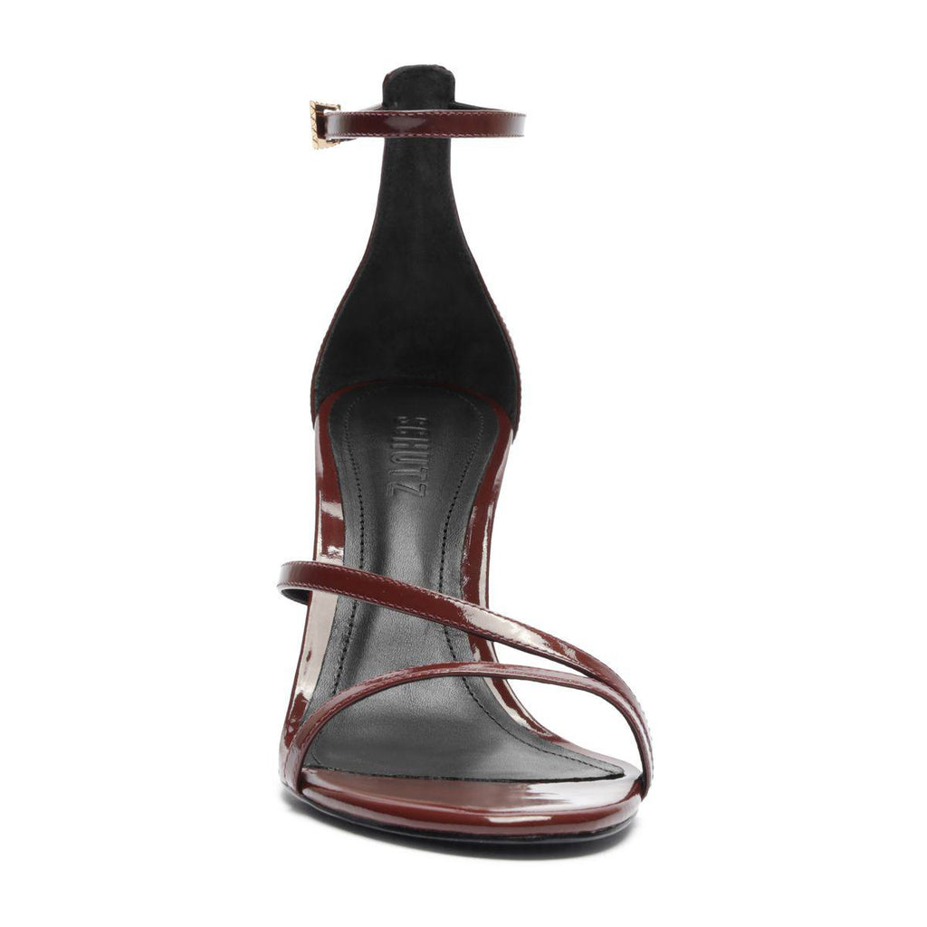 Front view of Tessa patent sandal in port burgundy showcasing glossy straps and stiletto heel with white background