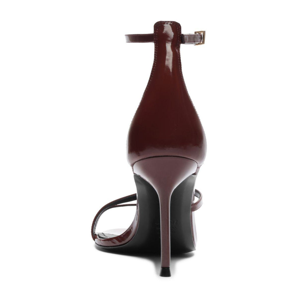 Rear view of Tessa Patent Sandal in Port Burgundy showcasing glossy patent leather straps and stiletto heel with a white background