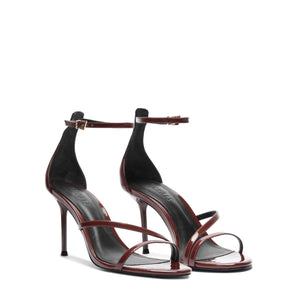 Angled view of Tessa Patent Sandal in Port Burgundy showcasing glossy patent straps and stiletto heels on a white background