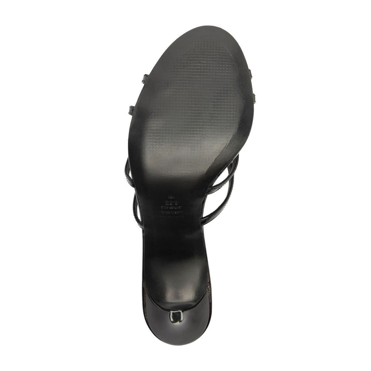 Bottom view of Marion Patent Sandal showcasing black leather outsole and stiletto heel on a white background