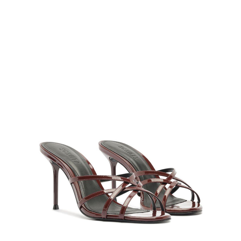 Three-quarter view of Marion patent sandal showcasing port burgundy straps and stiletto heels on a white background