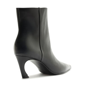 Side view of Lexi Leather Bootie in Black showcasing sculptural heel and pointed toe against a white background