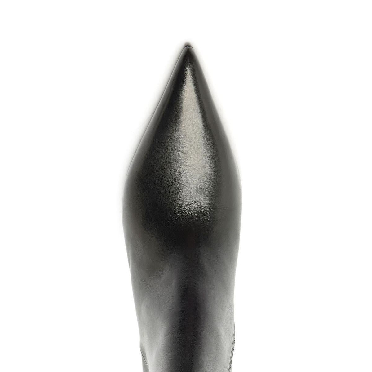 Close-up view of Lexi Leather Bootie in black showcasing its sharply pointed leather toe against a white background
