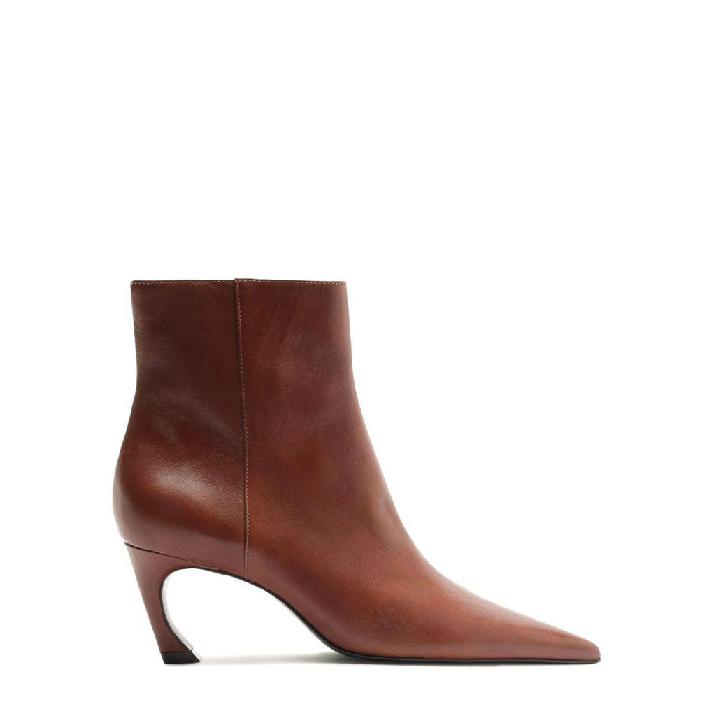 Side view of Lexi Leather Bootie in Warm Toffee showcasing pointed toe and sculptural curved heel with a white background