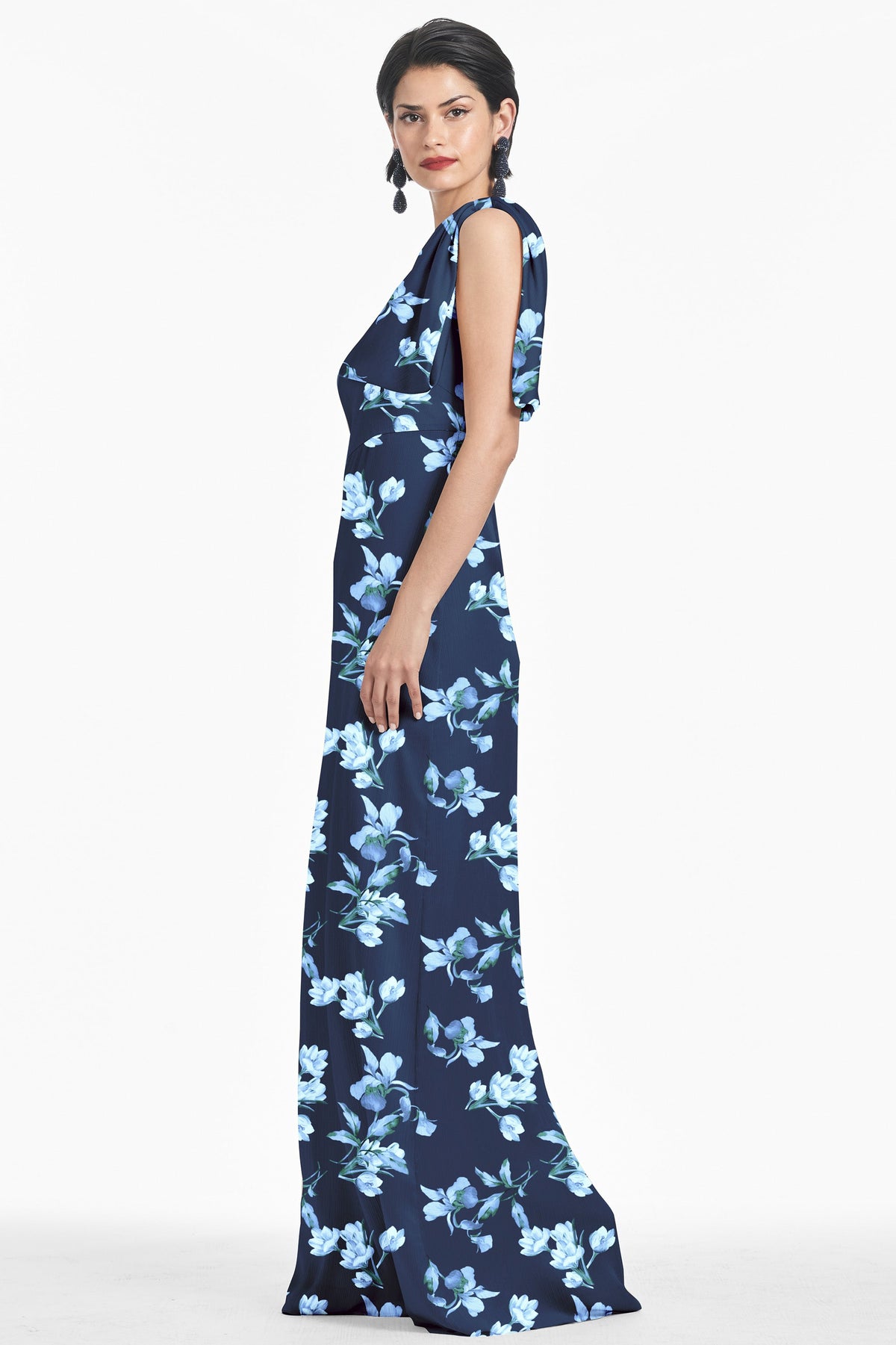 Side view of Chelsea Gown in Poseidon Venetian Petal showcasing floral print and shoulder bow on a model against white