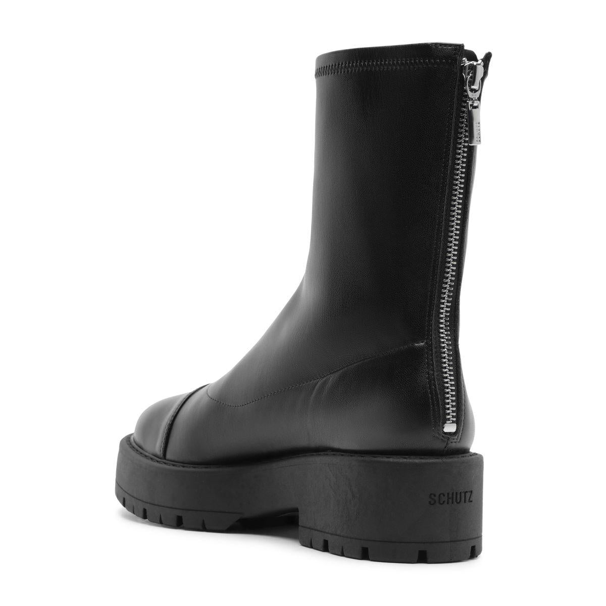 Three-quarter rear view of Rita Bootie in Black showcasing its side zip, round toe, and lug sole against a white background