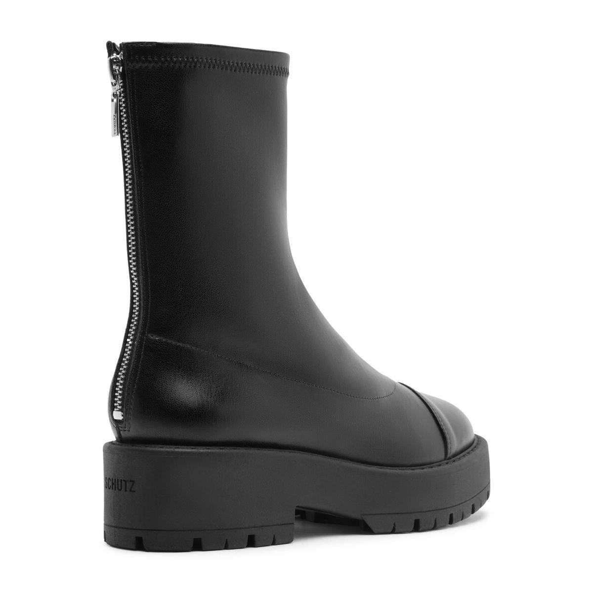 Side view of black Rita Bootie showcasing its lug sole and side zip closure with a white background