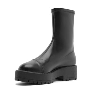 Three-quarter view of Rita Bootie in Black showcasing its round toe and lug sole with a white background
