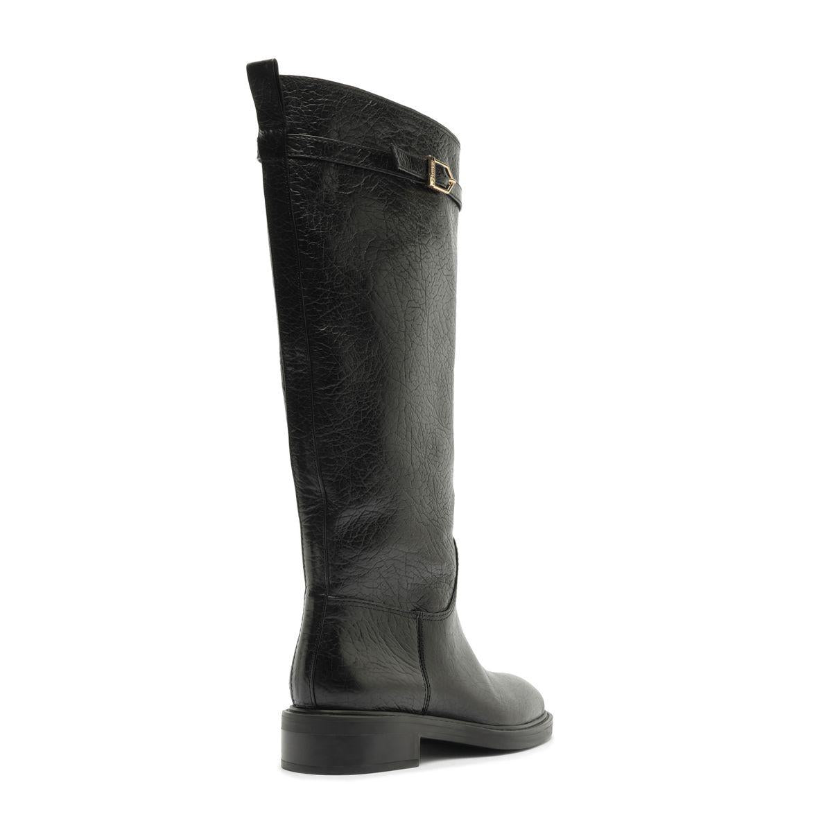 Side view of Bianca leather boot in black showcasing its knee-high shaft and low block heel against a white background
