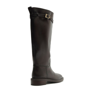 Side view of Bianca leather boot in Maplewood showcasing tall leather shaft, buckle strap, and low heel on a white background