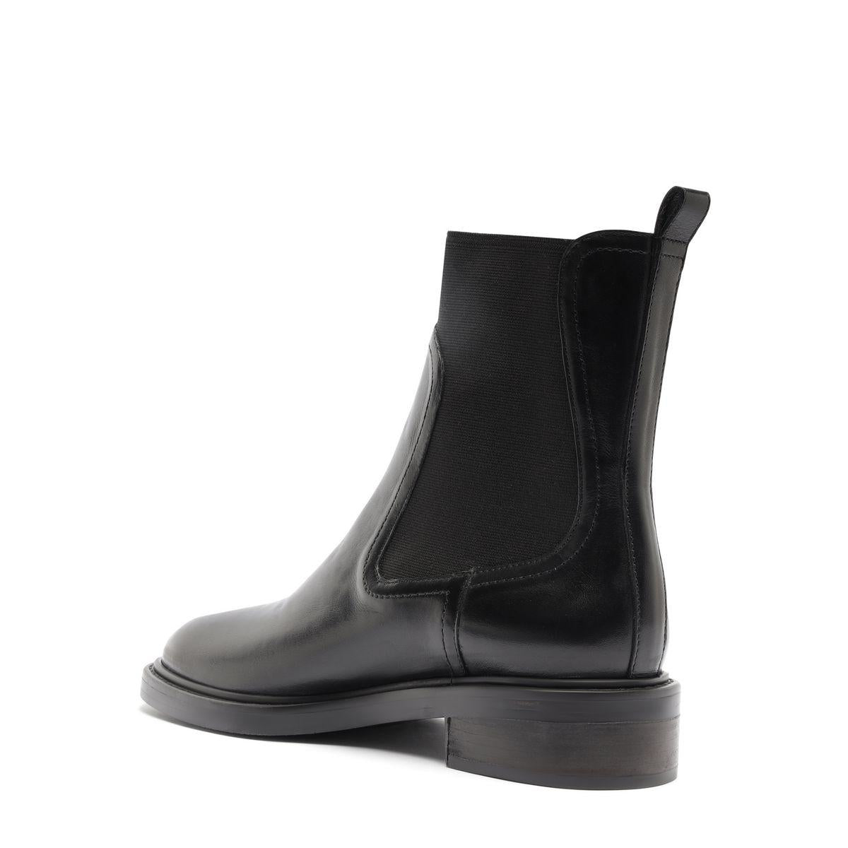 Side view of Olivia Bootie in Black showcasing its elastic side panel and block heel against a white background