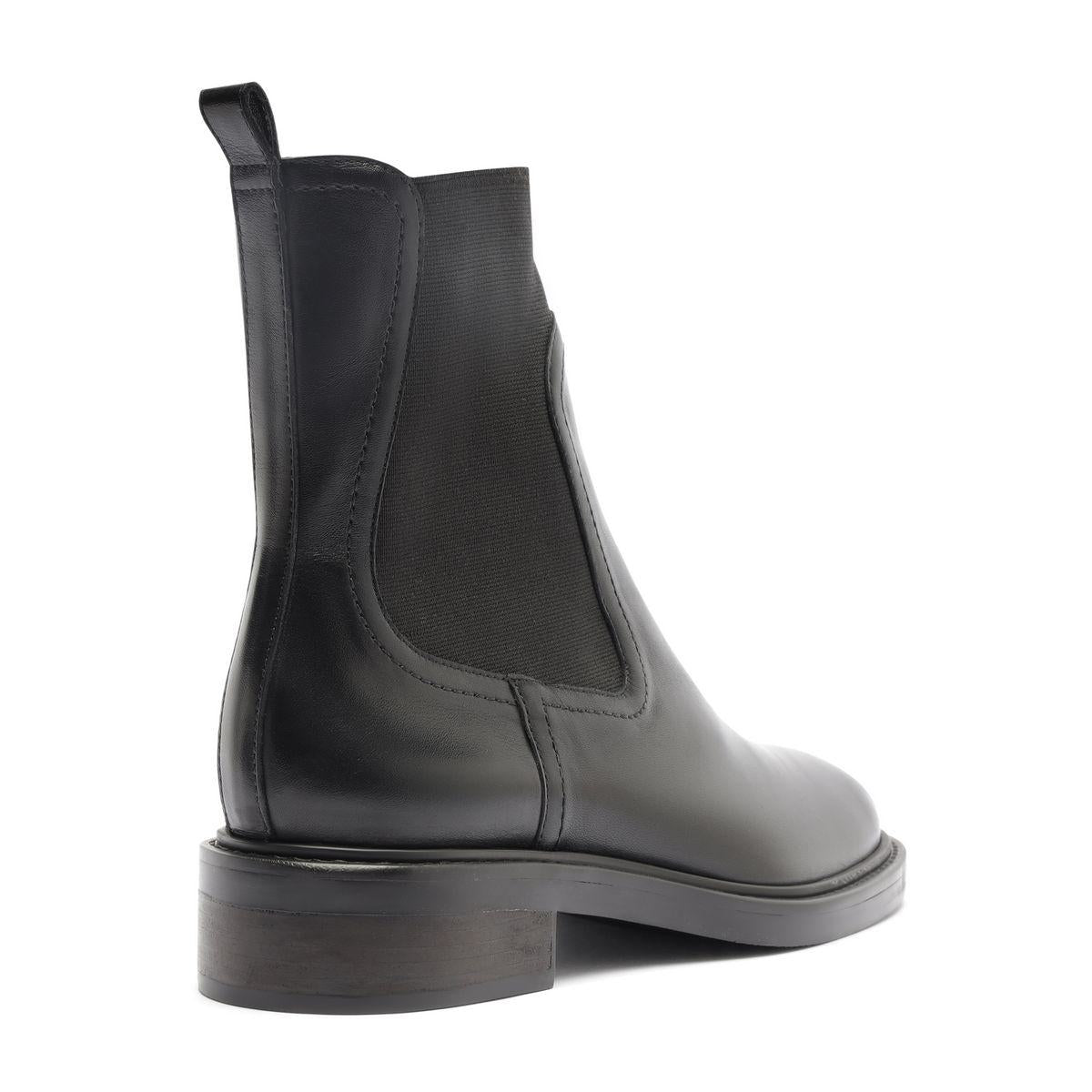 Side view of Olivia Bootie in black showcasing pull tab, elastic side panel, and low block heel with white background