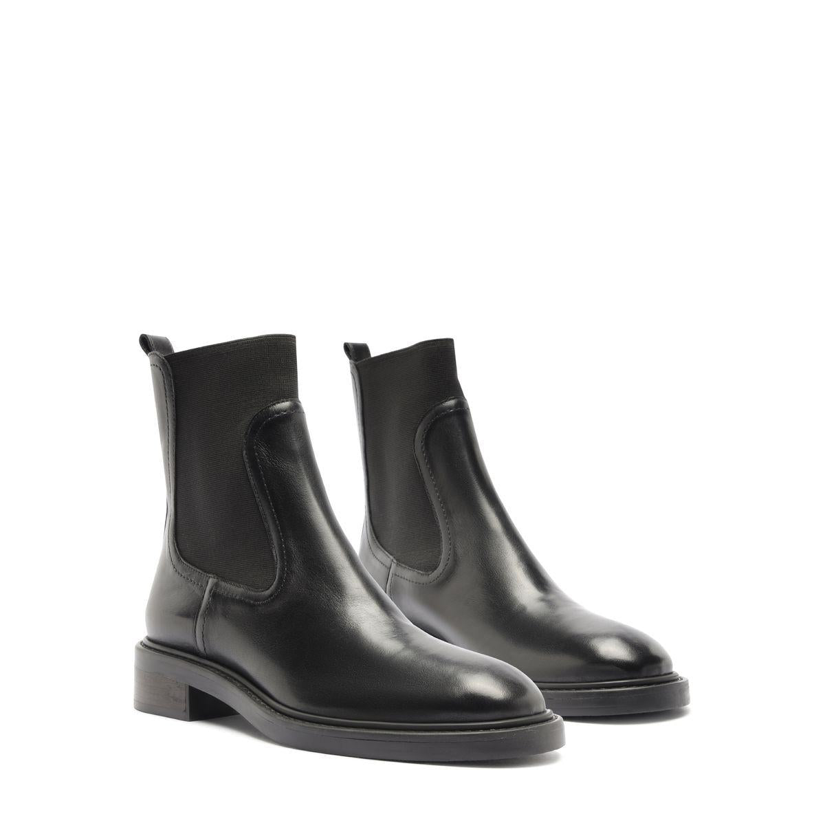 Front three-quarter view of Olivia Bootie in Black showcasing low block heels on a white background