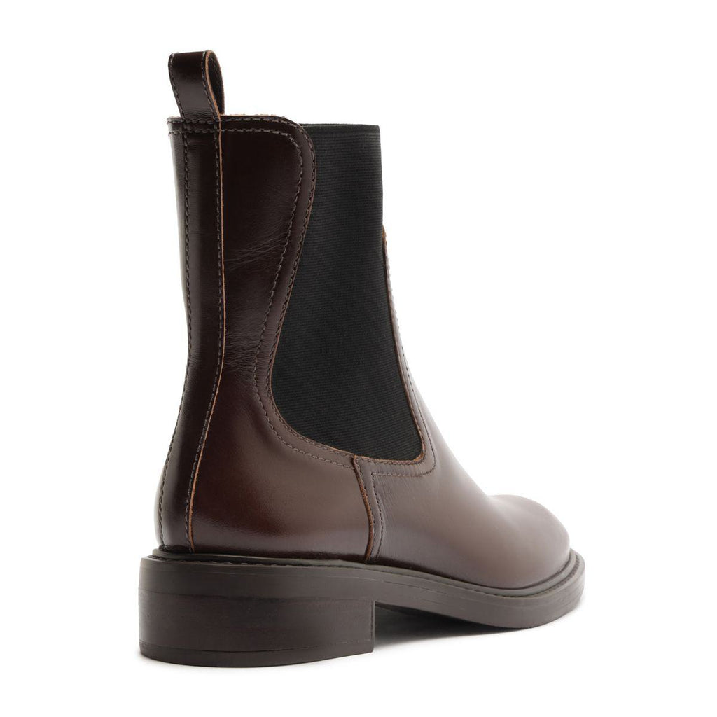 Rear three-quarter view of Olivia Bootie in Root Brown showcasing a black elastic side panel against a white background
