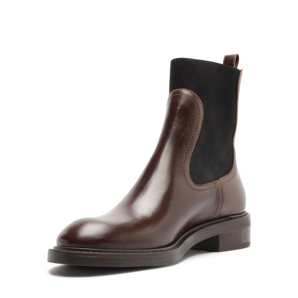 Front three-quarter view of Olivia Bootie in Root Brown showcasing black elastic side panels and block heel with a white background