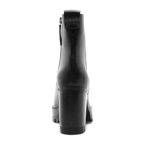 Rear view of 240 leather bootie in black showcasing block heel and side zipper with white background