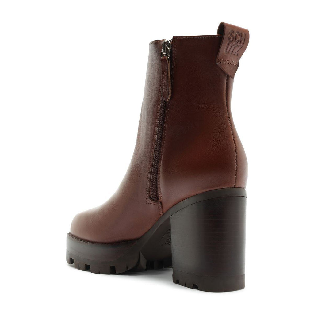 Three-quarter rear view of 240 leather bootie in warm toffee with block heel, lug sole, and side zipper on white background